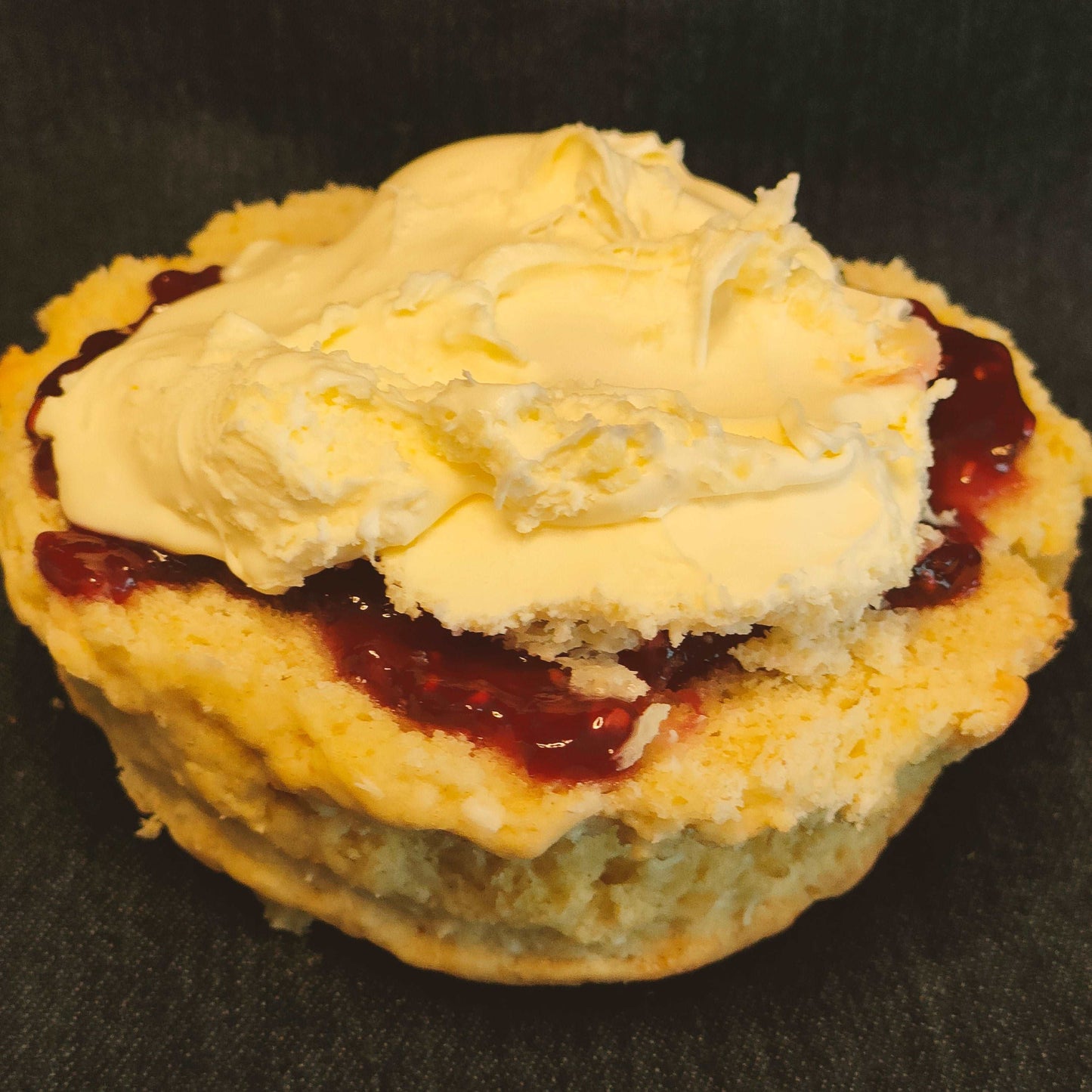 Coconut and raspberry cream tea ready to eat. Coconut scone, raspberry jam and rodda's cream. Delicious Cream tea by post
