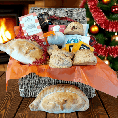 Christmas proper job gift hamper for two, with our delicious Christmas cream tea, Christmas pasty's cream tea chocolate bar, box of fairings, box of fudge and a Christmas pud.