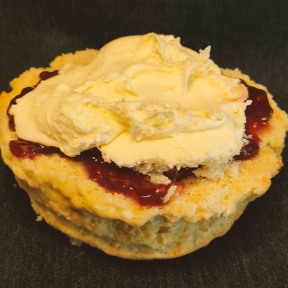 Coconut and raspberry cream tea ready to eat. Coconut scone, raspberry jam and rodda's cream. Delicious Cream tea by post